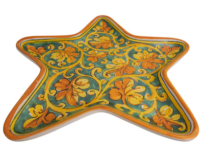Star tray with spiral vine leaf decoration on green background